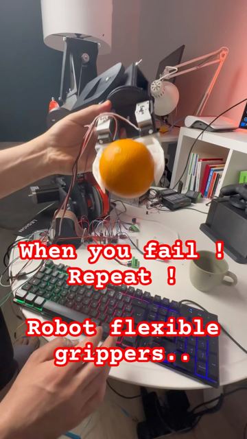 Soft TPU gripper holding an orange