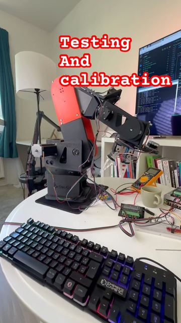 Six-axis robot arm on a desk during calibration